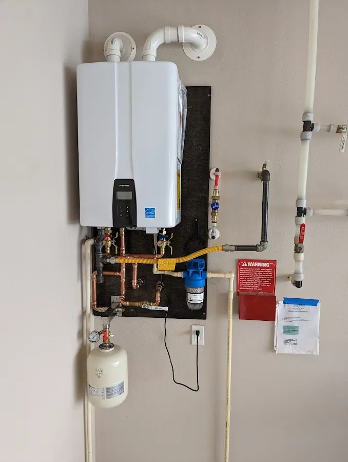 Professional plumber installing copper piping in a Lewiston home